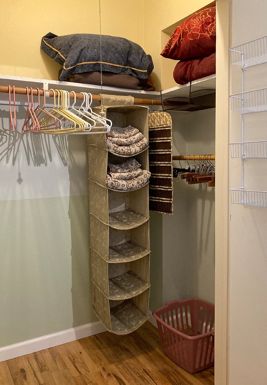 Closet right: 2 sets towels, laundry basket,  sweater hanger, pants pole w/ hangers, extra pillows & blankets.