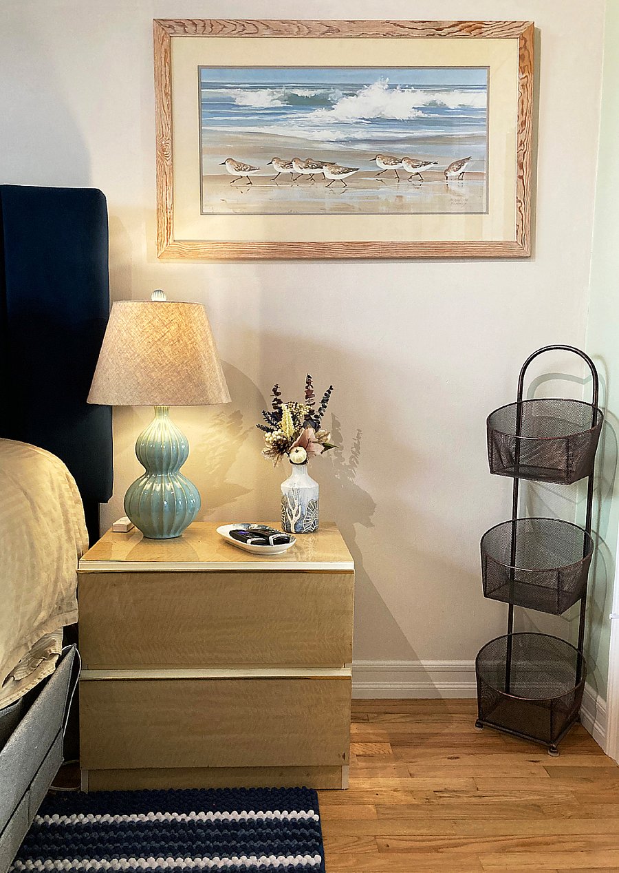 Nightstand w/ 2 deep storage drawers, tiered mesh basket caddy, bedside organizer w/ charger cable, TV remotes in tray.
