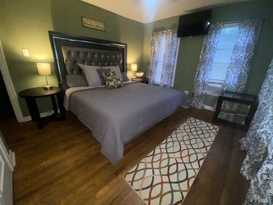 Comfy King bed with double closet, lots of windows, but curtains that can be drawn to decrease the light. Windows look out to front of home. 