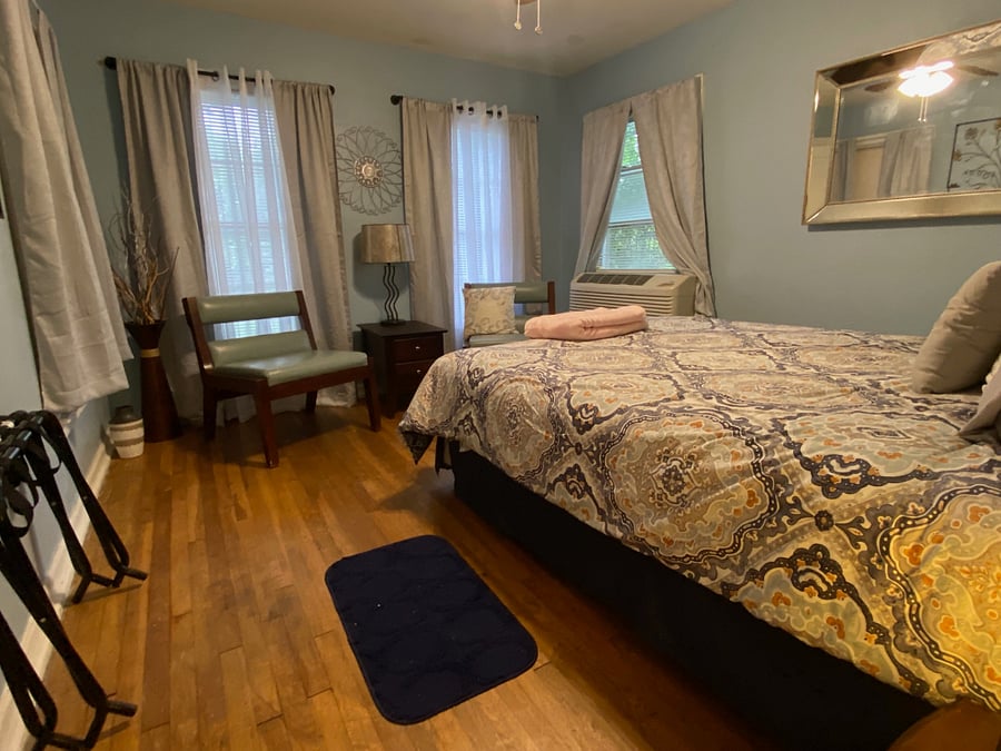 Queen bedroom has extra seating, room darkening curtains, large mirror, large closet with home safe inside.