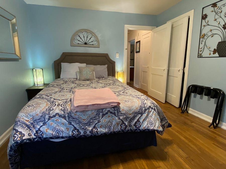 Second bedroom down the hall from first with bathroom between. Faces backyard. Comfy Queen bed with large closet, TV, A/C unit and ceiling fan.