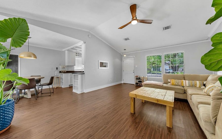 Living room with views of kitchen and dining areas