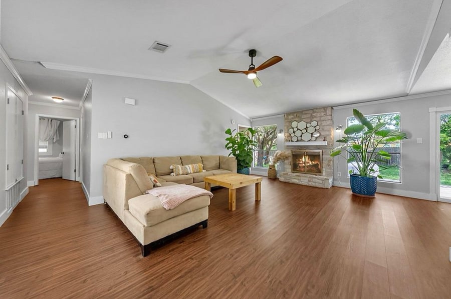 a broader shot of the living room with views of hallway to guest room