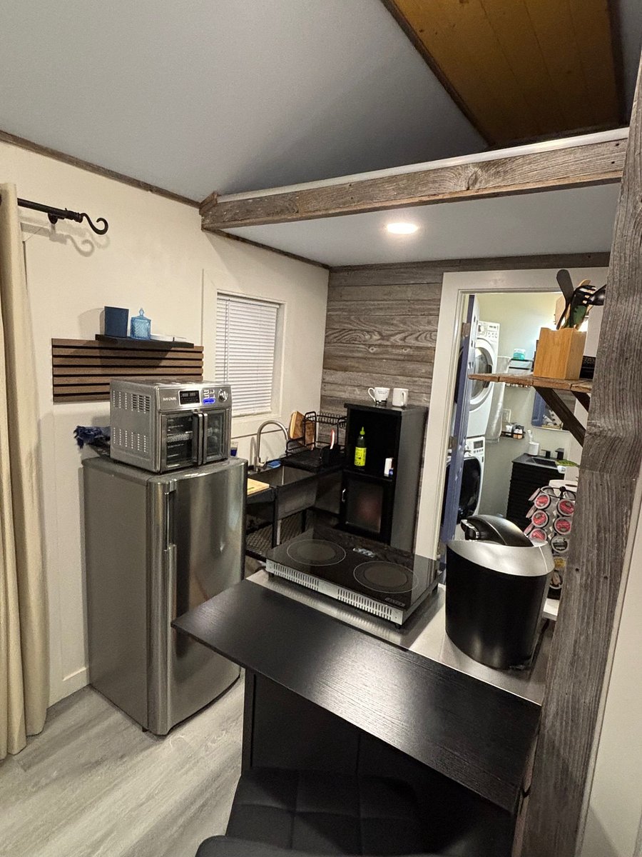 Kitchenet and stacked washer/dryer.