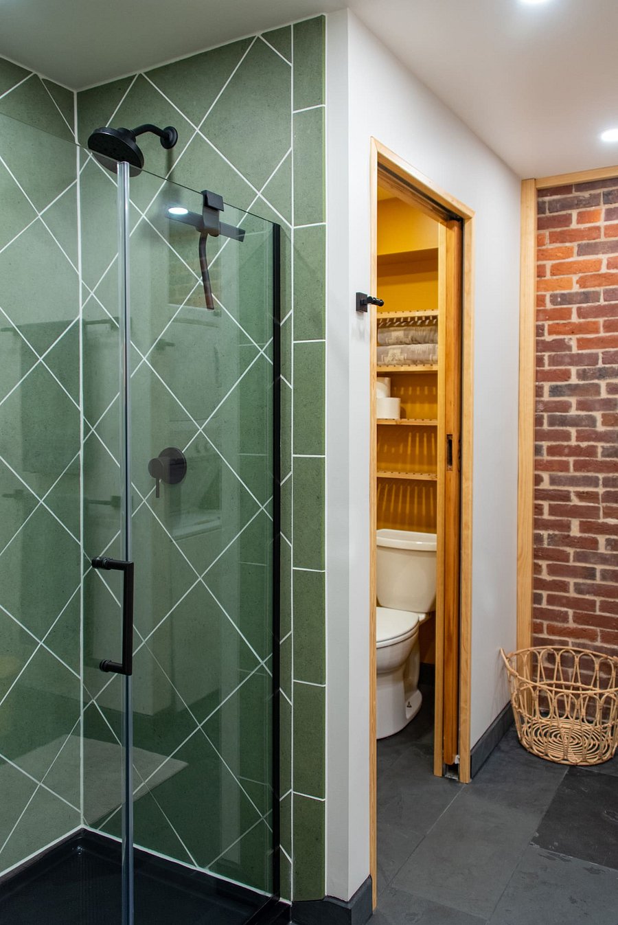 Shower (handle works by pulling out, then twisting), toilet pocket with door, and laundry to the right