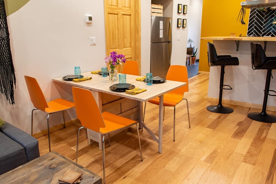 The table has a fold out leaf that allows for it to be dining for up to four people or a big workspace desk