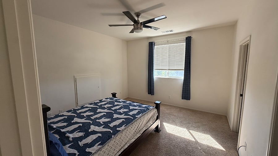 upstairs bedroom with walk in closet and private bath