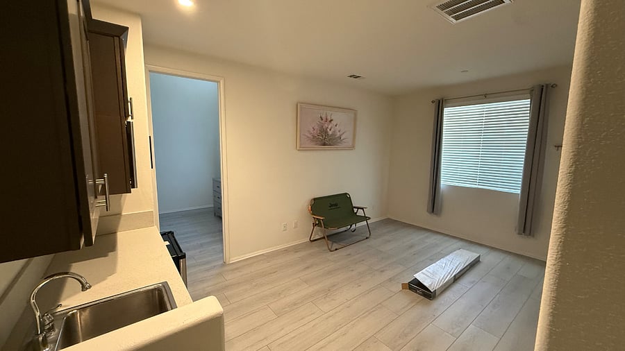Living room of mother in law suite with separate entrance, kitchenette and bathroom with shower and toilet. 