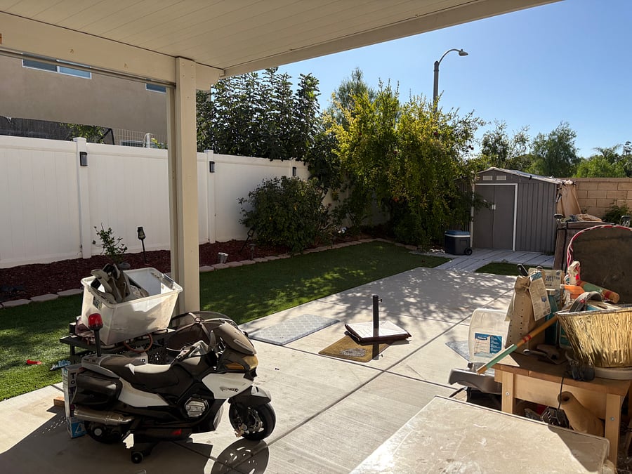 backyard with artifical grass, and a variety of fruiting trees: Lime, Pomegranate, nectarines, and loquat. 