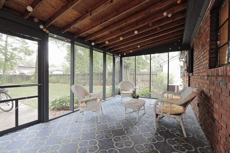 Screened in porch looks out to private yard
