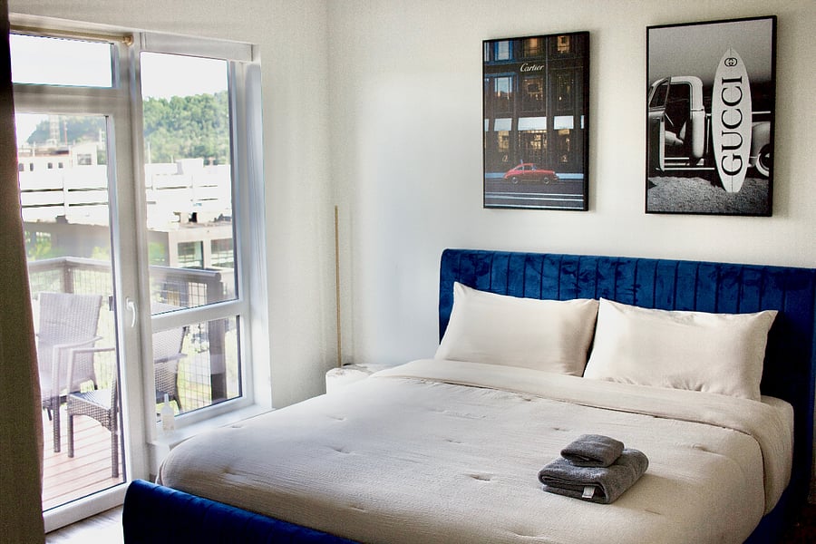 The bedroom offers a king bed, TV, walk in closet, additional closet, and a balcony.