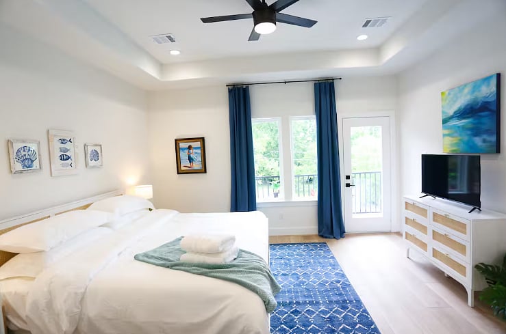 Bedroom One includes a spacious en suite bathroom and a balcony - perfect for enjoying morning coffee or wine in the afternoon! All four bedrooms boast a king size bed with 100% cotton sheets, a Roku TV, blackout curtains, and a walk-in closet. 