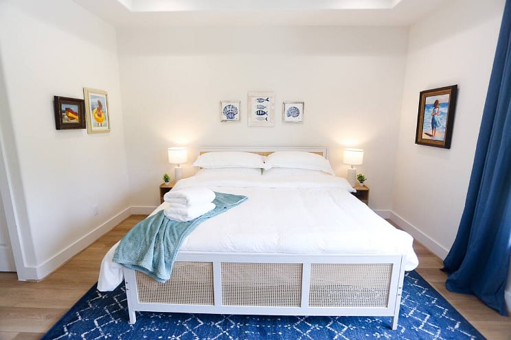 Bedroom One includes a spacious en suite bathroom and a balcony - perfect for enjoying morning coffee or wine in the afternoon! All four bedrooms boast a king size bed with 100% cotton sheets, a Roku TV, blackout curtains, and a walk-in closet. 
