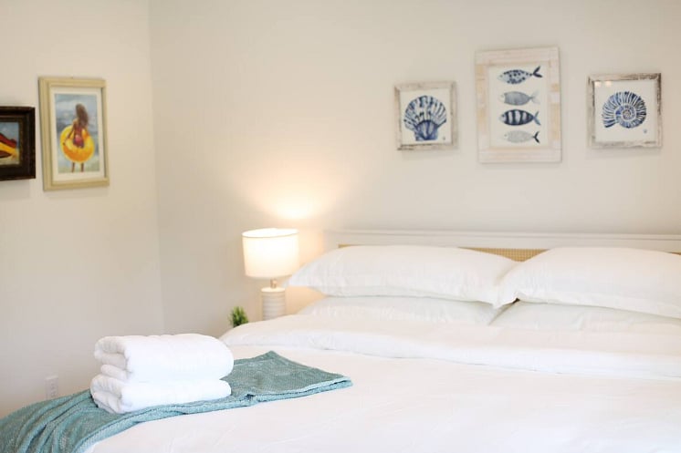 Bedroom One includes a spacious en suite bathroom and a balcony - perfect for enjoying morning coffee or wine in the afternoon! All four bedrooms boast a king size bed with 100% cotton sheets, a Roku TV, blackout curtains, and a walk-in closet. 