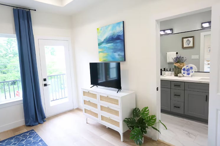 Bedroom One includes a spacious en suite bathroom and a balcony - perfect for enjoying morning coffee or wine in the afternoon! All four bedrooms boast a king size bed with 100% cotton sheets, a Roku TV, blackout curtains, and a walk-in closet. 