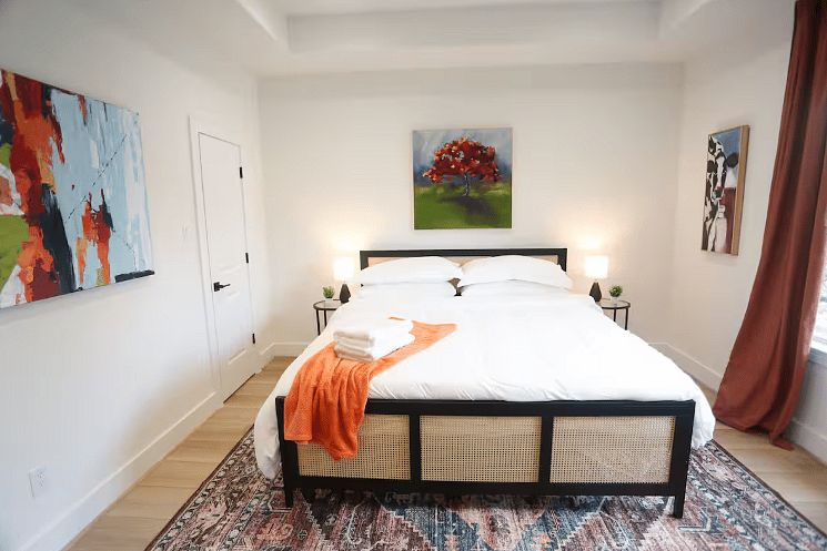 Bedroom Four includes a spacious en suite bathroom. All four bedrooms boast a king size bed with 100% cotton sheets, a Roku TV, blackout curtains, and a walk-in closet. 