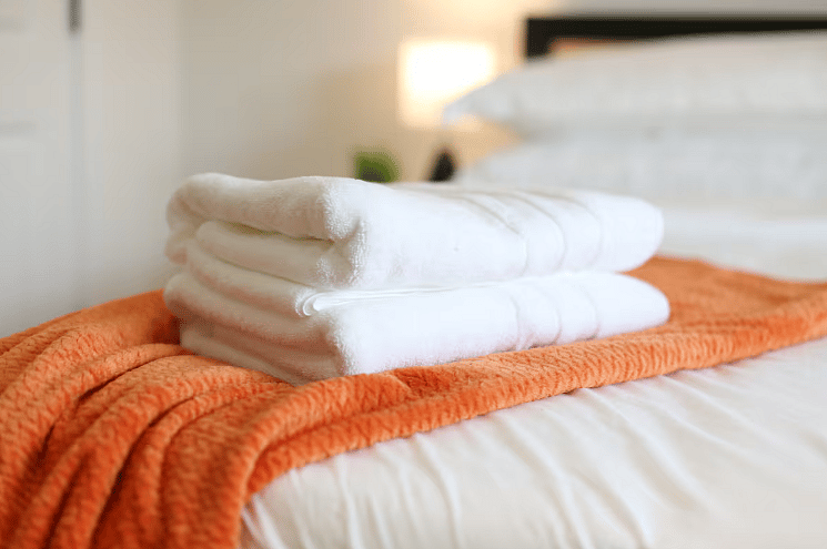 Bedroom Four includes a spacious en suite bathroom. All four bedrooms boast a king size bed with 100% cotton sheets, a Roku TV, blackout curtains, and a walk-in closet. 