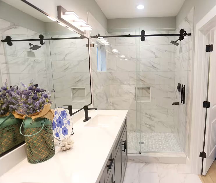 Spacious & modern en suite bathroom for Bedroom One. Includes walk-in shower & beautiful double vanity with plenty of counter space. Each bathroom contains a hair dryer, shampoo, conditioner, body wash, and hand soap.