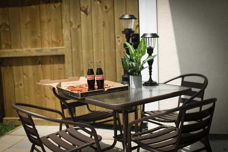 Relax on the back patio  with a firepit, charcoal grill, table & chairs, games, and a privacy fenced back yard. Pet-friendly!