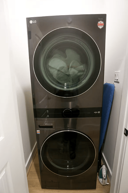 Brand-new stackable washer and dryer with a full size ironing board and iron!