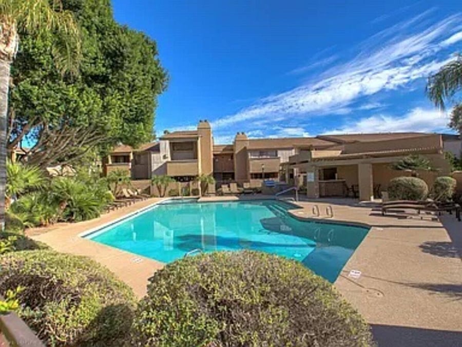 Community heated pool with bbq, outdoor dining, lounge chairs and a hot tub.