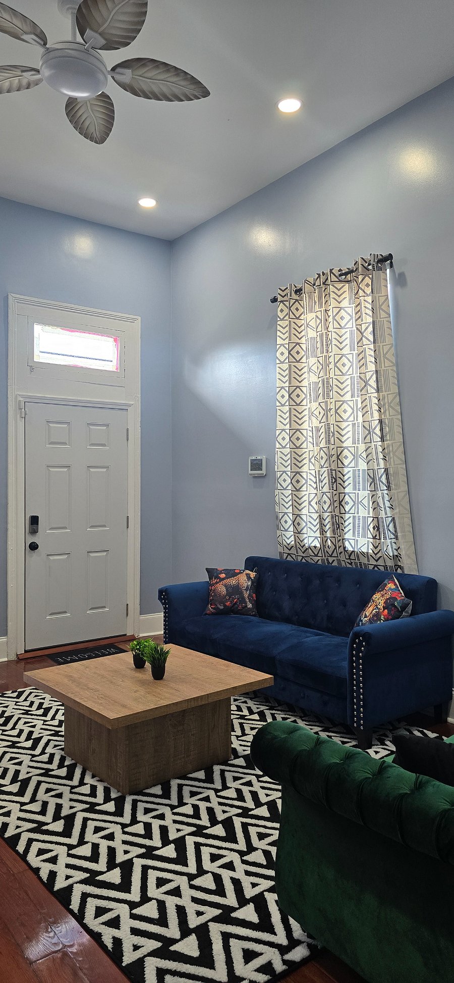 Living room area featuring historic refinished hardwood floors.