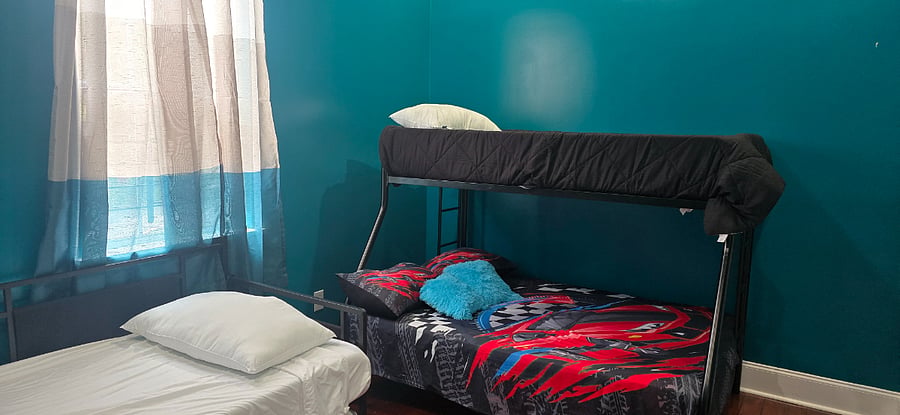 Bedroom with Full sized bottom bunkbed, twin on top, plus daybed with two twins and two closets.