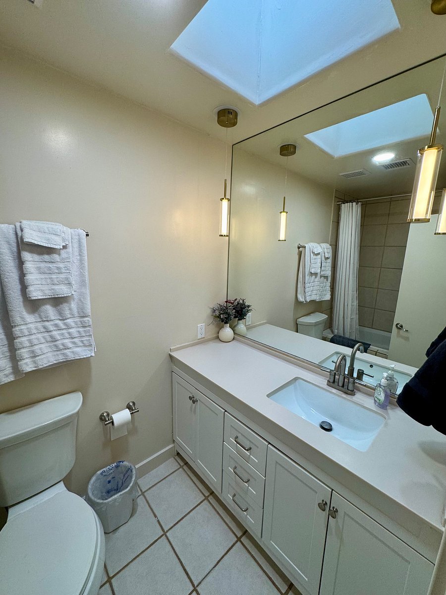 Main bathroom in the hallway between bedrooms. Both bathrooms have skylights, exhaust fans, extra towels, soap and shampoo and cleaning supplies to get you started.