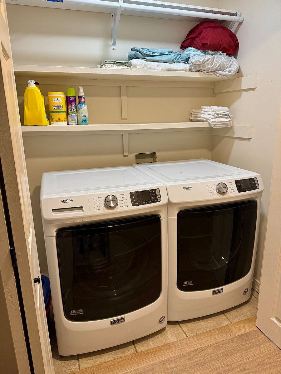 Laundry with full-sized new washer and gas dryer. Cleaning supplies, detergent are included to get you started. There is also a broom and mop, and an iron and small ironing board.