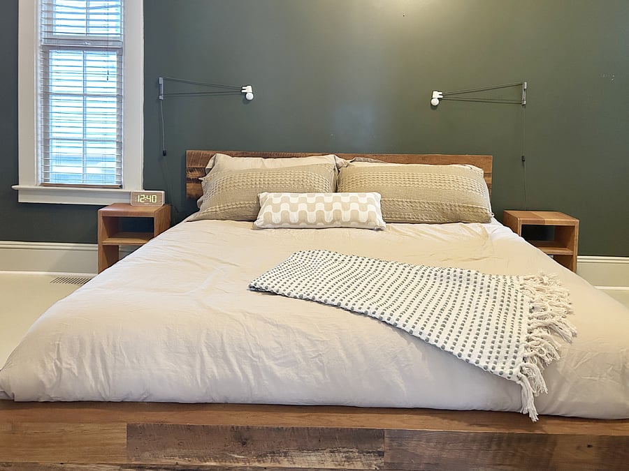 Primary bedroom features a firm king-sized mattress
