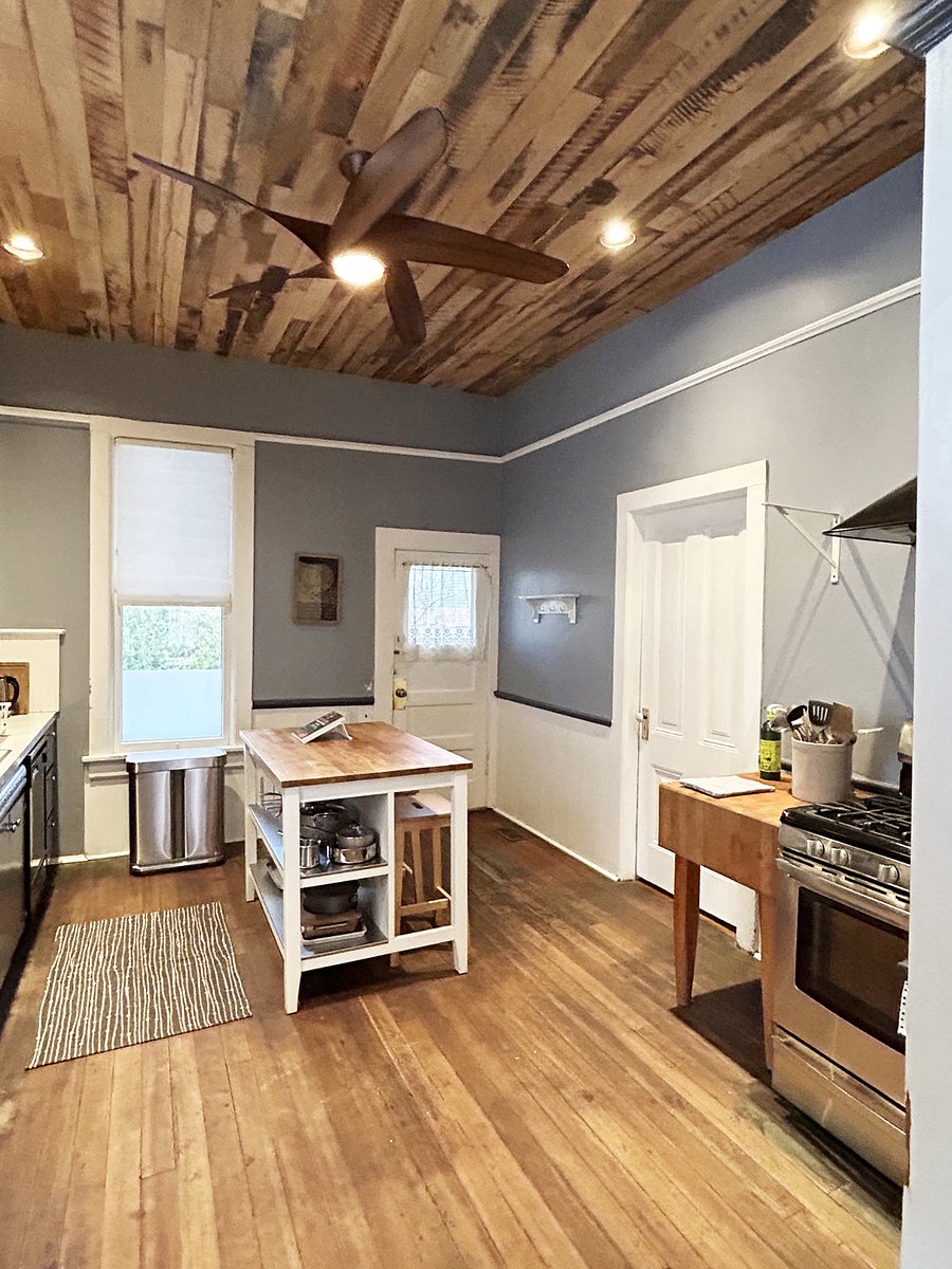 Kitchen has microwave, dishwasher, SS refrigerator, gas range and hood. It's fully stocked dishware, glassware, utensils, and cookware.