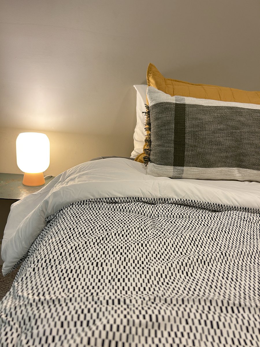 Twin bed with extra bedding stowed underneath