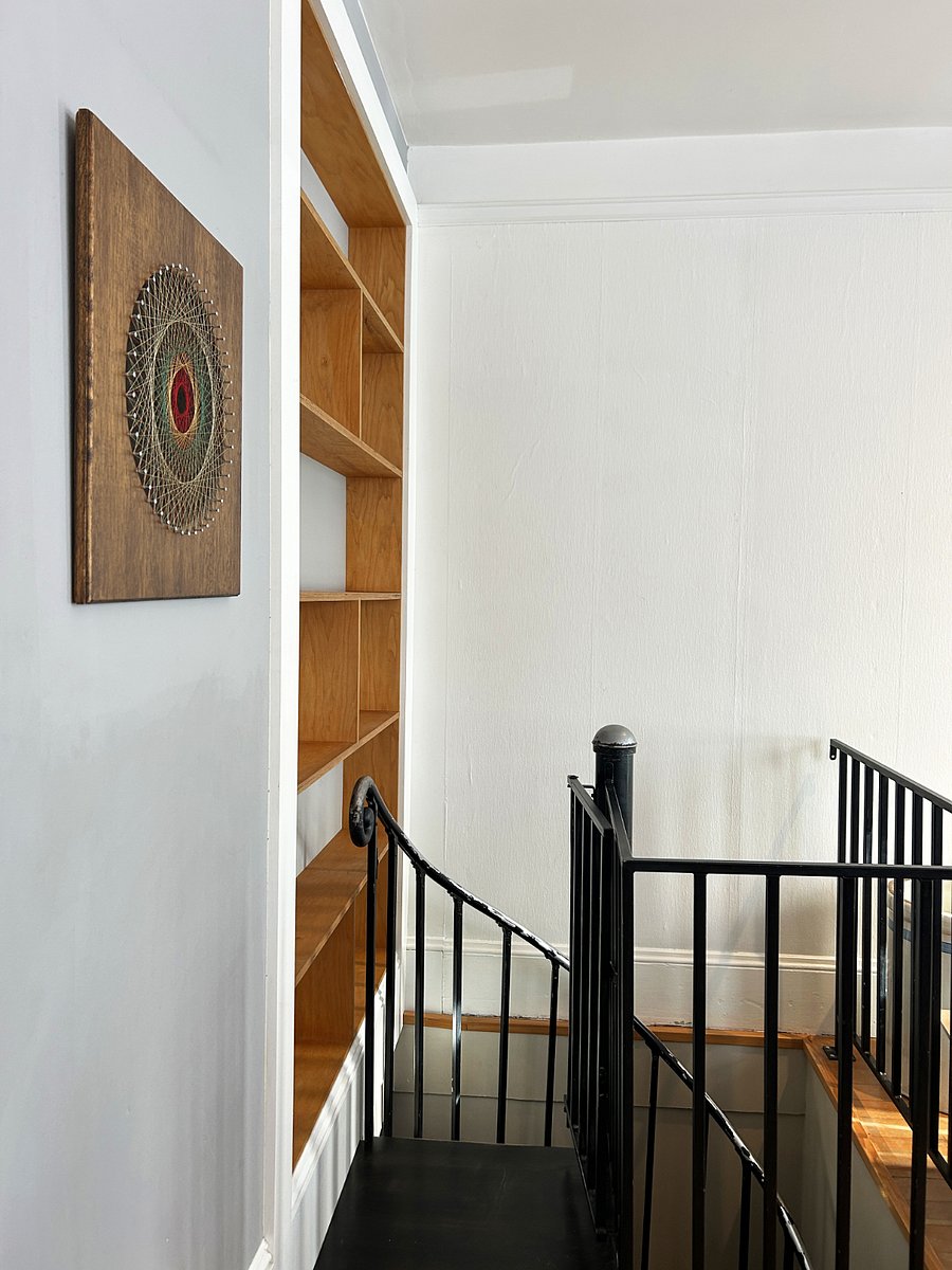 Spiral staircase leads to second bedroom/dedicated office, secondary living room, yoga or meditation nook, laundry and guest storage space in the unfinished part of the basement