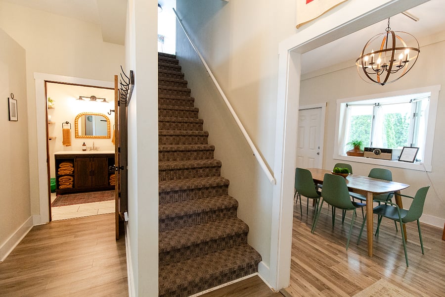 The staircase to the upstairs bedrooms is located off the entryway.