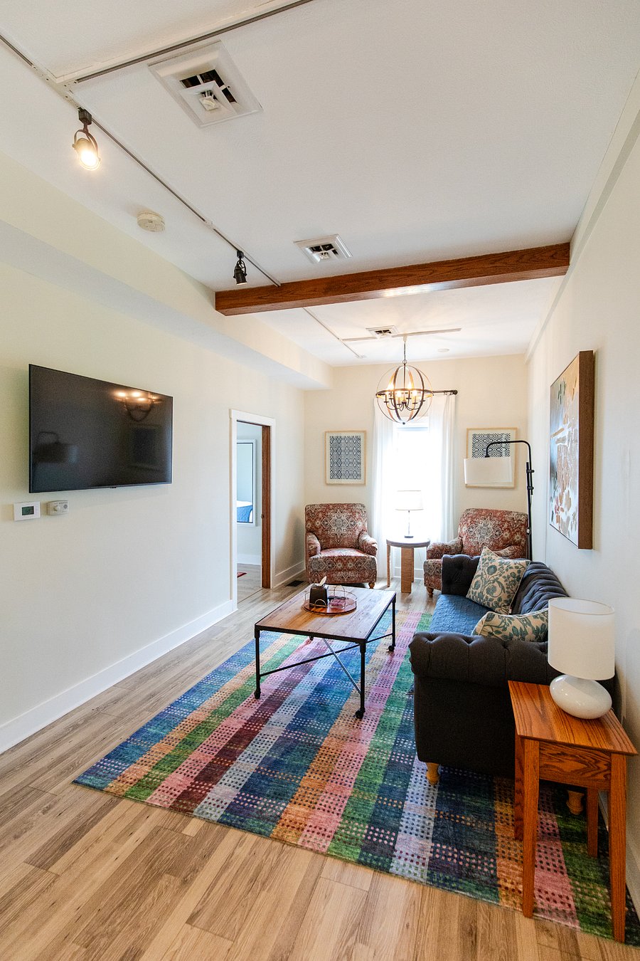 The downstairs bedroom is located off the living room.