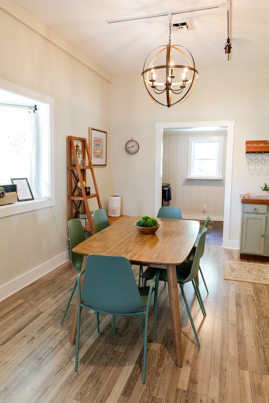 The dining room is located between the kitchen and living room.