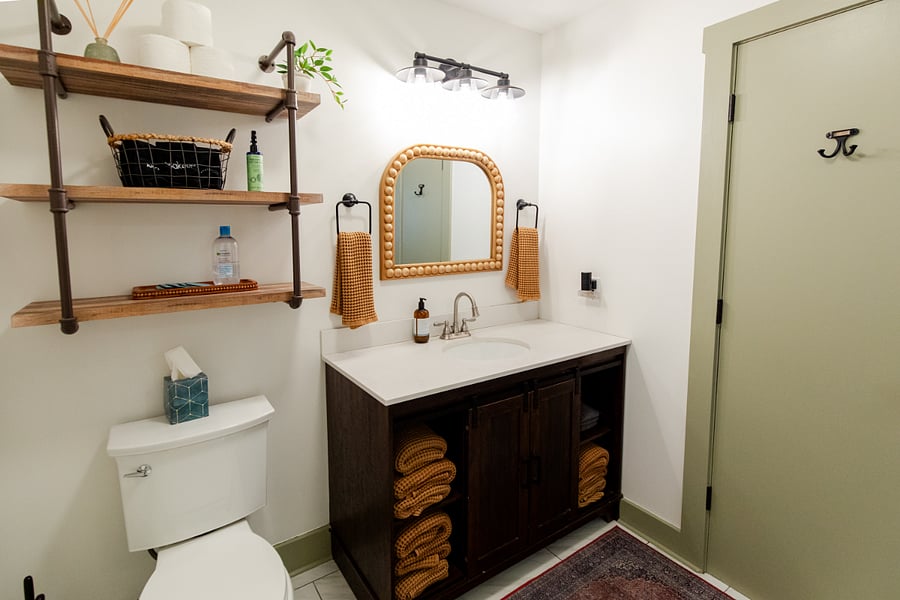 The bathroom has a single sink vanity and walk-in shower. (Bath linens are provided for STR guests).