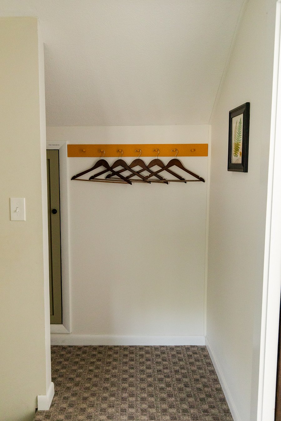 A peg rail located outside of bedroom 2.