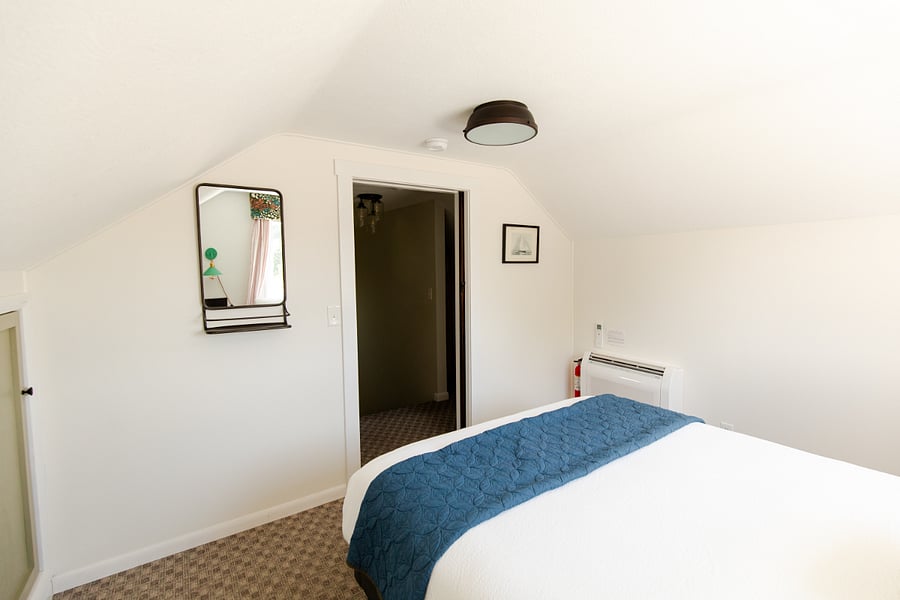 Bedroom 2 has pocket doors and is located at the top of the staircase.