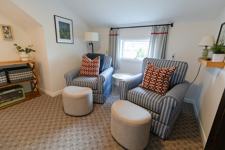 The upstairs level has a cozy space with a TV for relaxing between the two bedrooms.