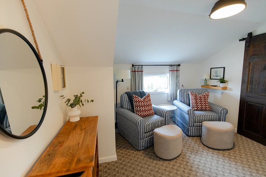 The upstairs level has a cozy space with a TV for relaxing between the two bedrooms.
