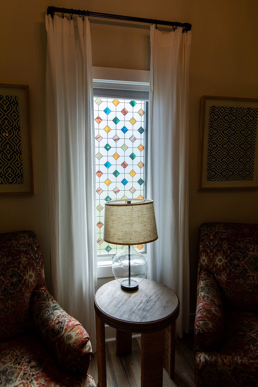 The living room window with its cheery stained glass finish adds joy and provides privacy.