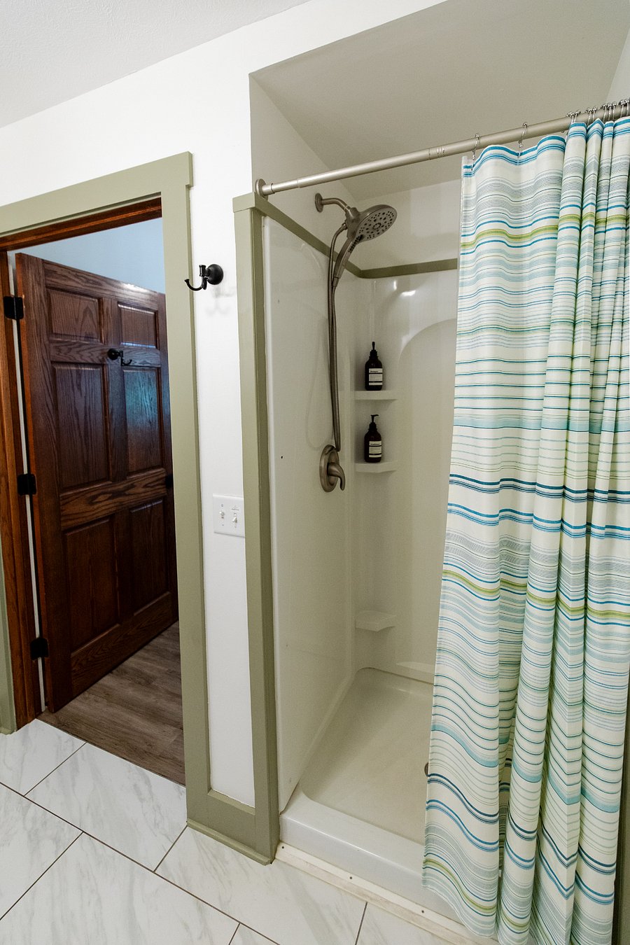 The bathroom has a walk-in shower. (Shower products are provided for STR guests).