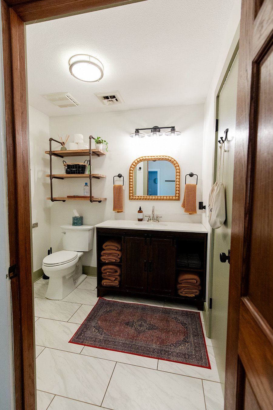 The bathroom has a single sink vanity and walk-in shower. (Bath linens are provided for STR guests).