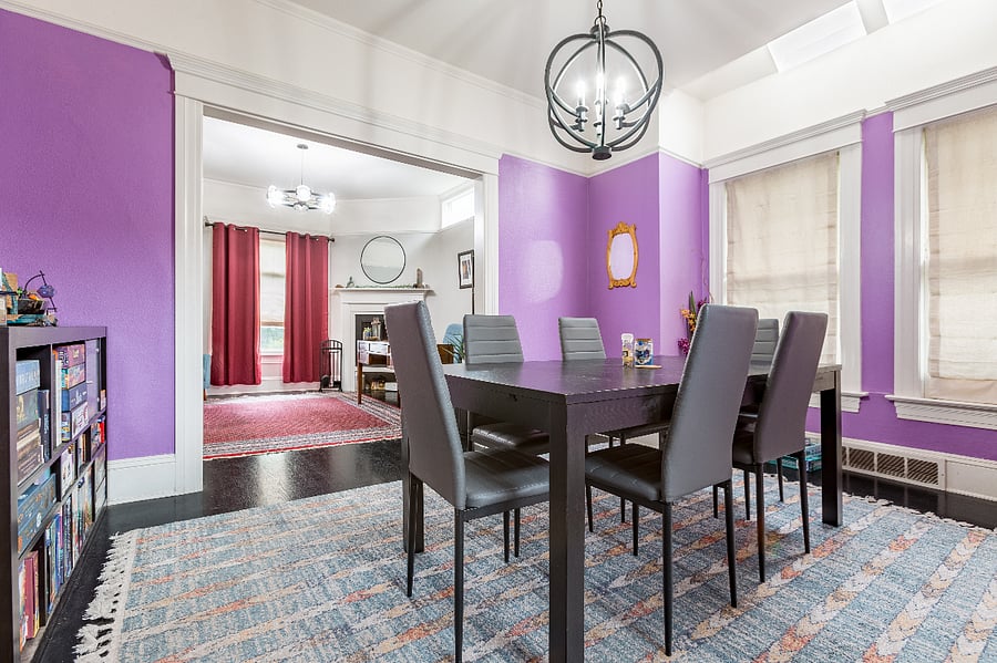 The dining room has a large table and lots of board games and puzzles