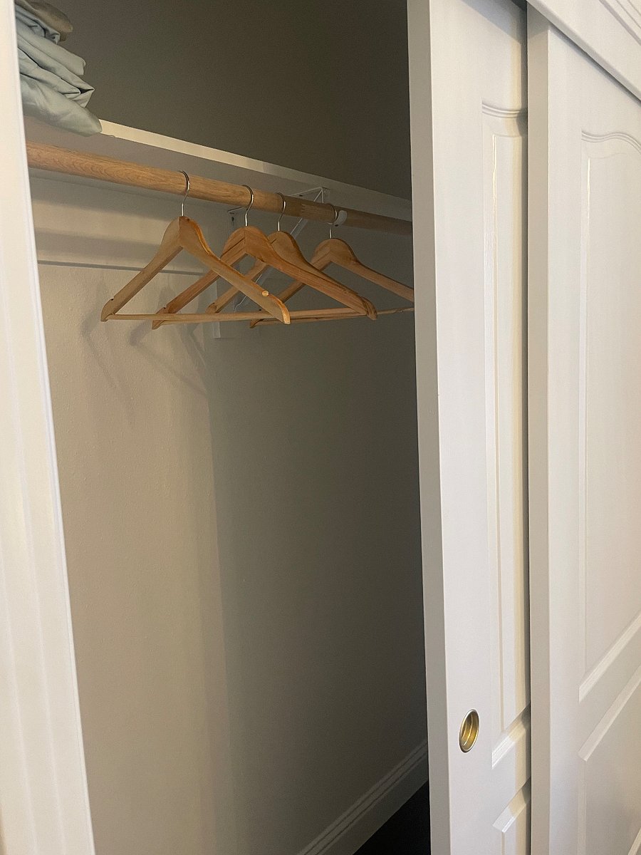 Every closet comes with a laundry basket and wooden hangers.