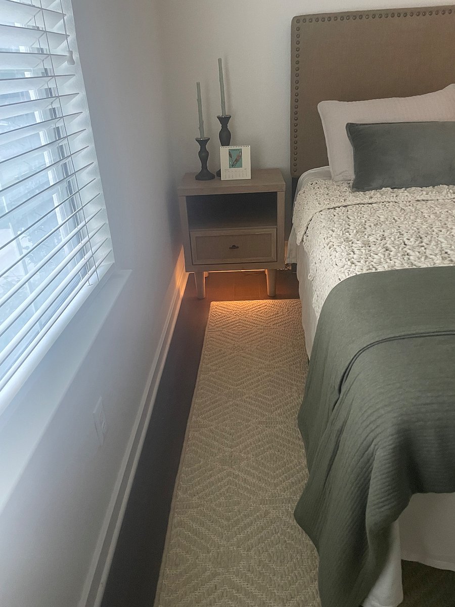 The Green Room has night light bed side table with phone charging.