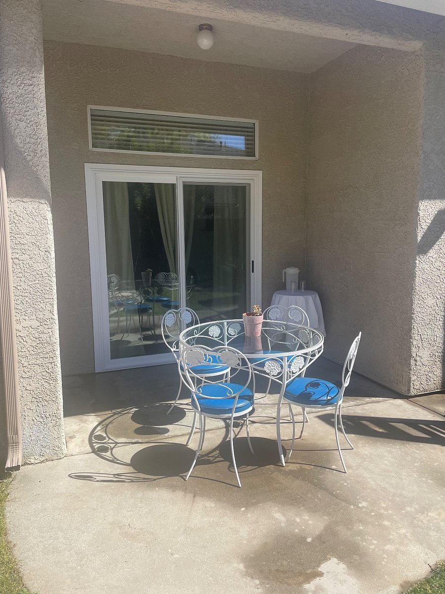 The side patio has plenty of space to move the table to shade on hot days.