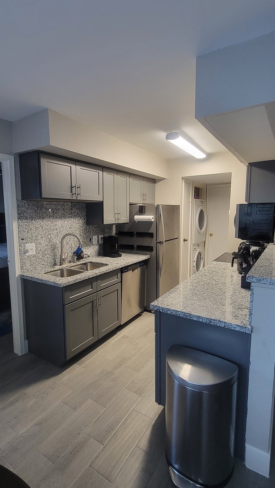 Kitchen with full size stackable washer and dryer view