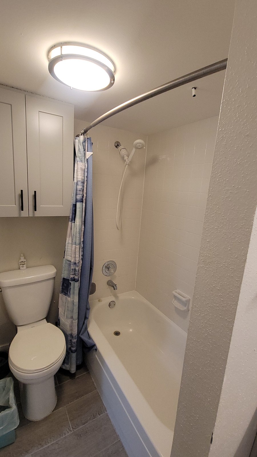Shower area of 2nd bathroom equipped with 3 shelved wall cabinet